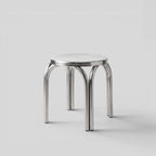 BY–EA Studio Stool in polished stainless steel with a minimalist stackable design, suitable as a seat or side table.