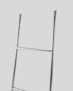 BY–EA Studio Ladder Rack in minimalist stainless steel with a sleek, leaning design for home or creative workspaces.