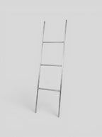 BY–EA The Studio Ladder Rack in brushed stainless steel, a minimalist leaning storage solution for towels or blankets.