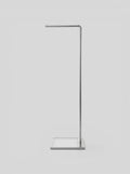 BY–EA Studio Rack featuring a minimalist brushed metal garment stand with a square base and single hanging rail