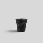 ESTYNE Studio black ceramic Form Cup with a hand-formed sculptural silhouette and a smooth glazed finish.