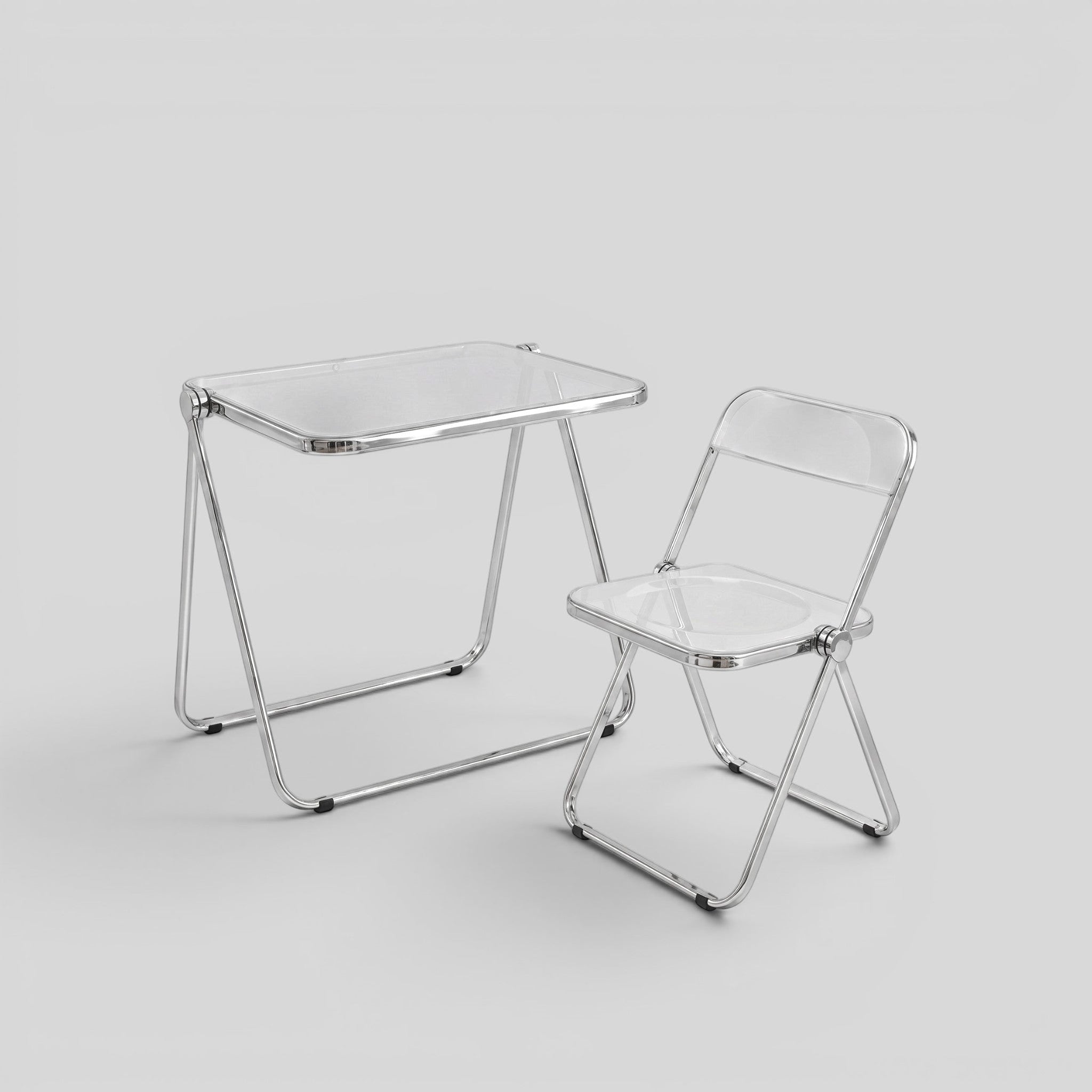 ESTYNE Studio folding chair and table set with transparent acrylic seats and polished chrome frames.
