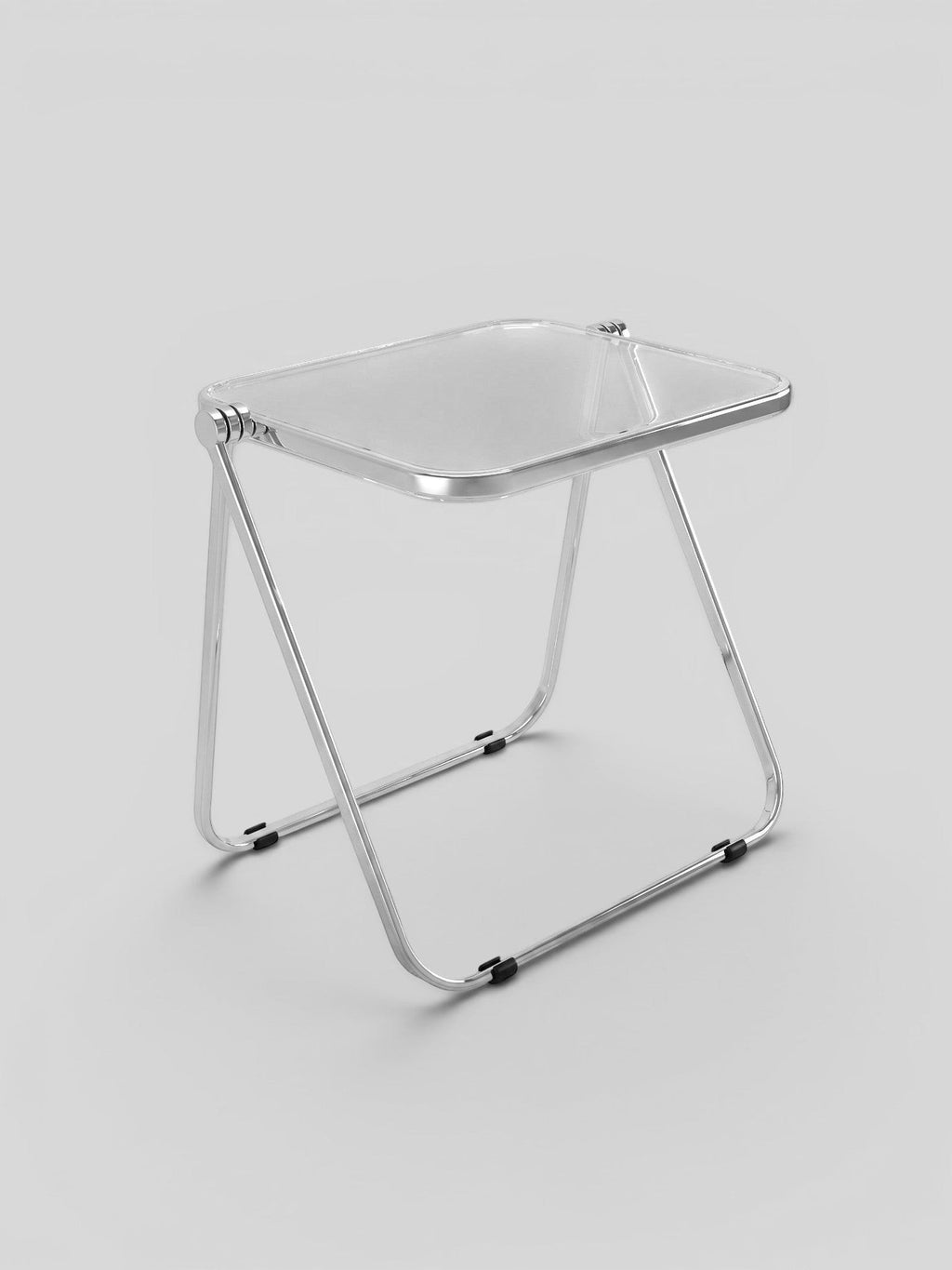 Novage Studios modern folding chair with a transparent acrylic seat and a polished chrome metal frame.